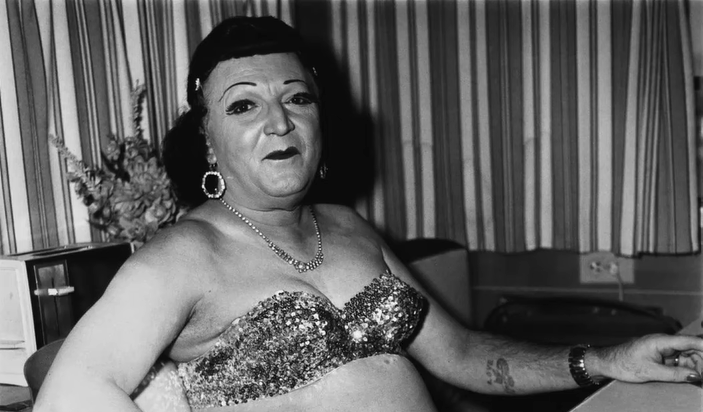  Man wearing women's clothes, sitting in a bra and makeup