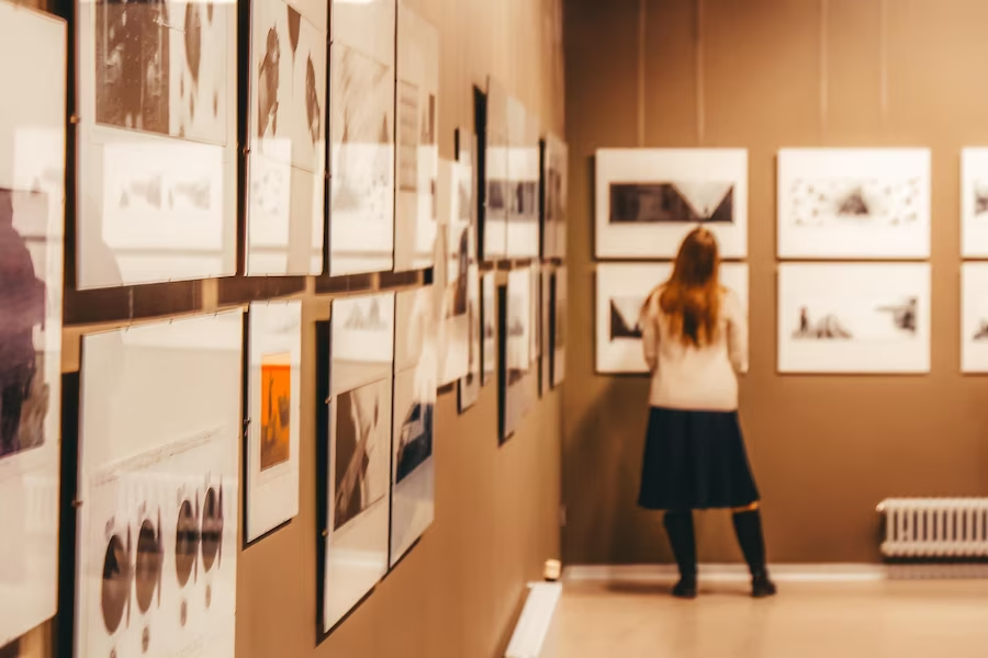 Woman observing artwork in a museum