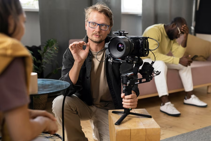 A director with a camera talking to a woman in front of him