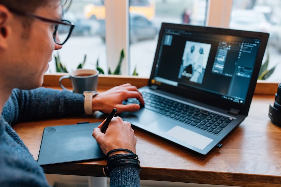 Man editing photo on laptop